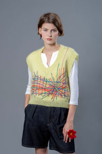 Thumbnail for Woman wearing a yellow mohair vest. The vest has a multitude of colourful embroidered lines in its center 