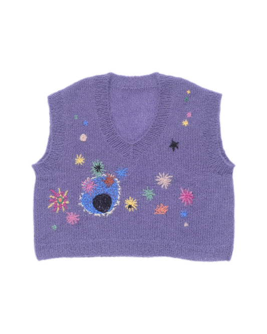 Purple mohair vest laid flat on white background. The vest is adorned with a multitude of colourful embroideries that resemble flowers.