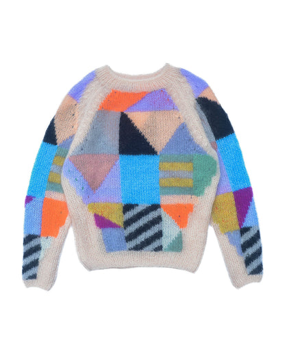 Mohair sweater laid flat on white background. The sweater is beige and is covered with colourful abstract colour block patterns on most of its surface.