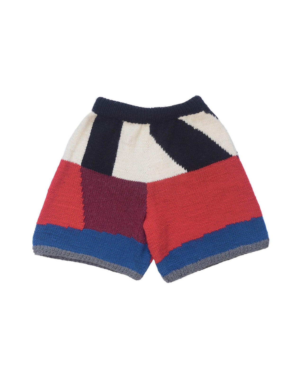 Wool bermuda shorts from the back layed flat. Black, white, bordeau, red and white colour block pattern on shorts. 