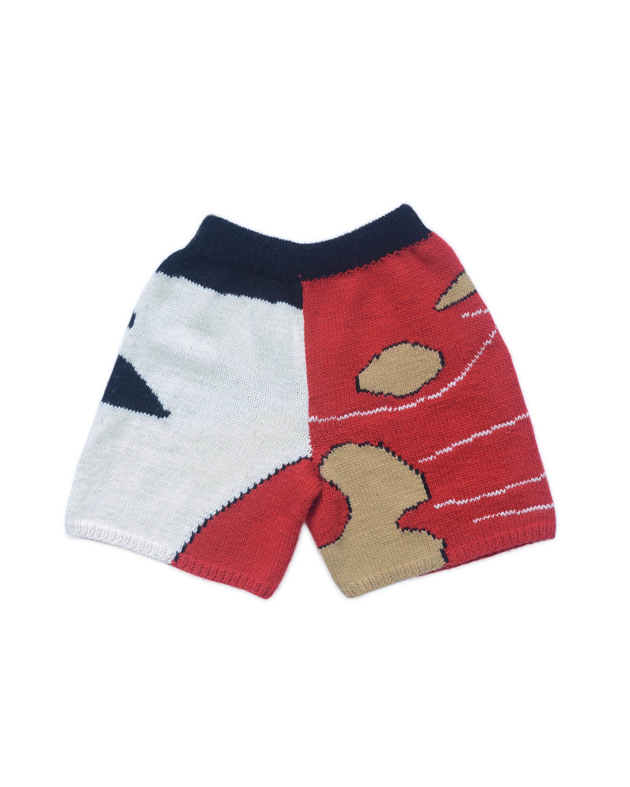 Back of wool bermudas on white background. Red, white, beige and black colour block patterns decorate the bermuda shorts. 