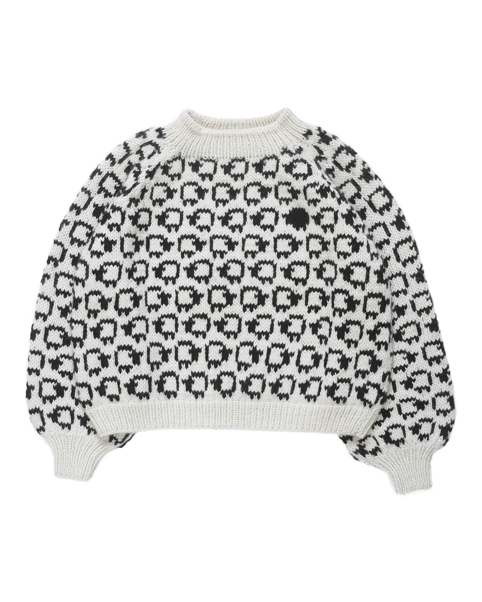 White wool sweater layed flat on white background. On the sweater is a herd of white sheep going left to right all around and a single black sheep on the front. 