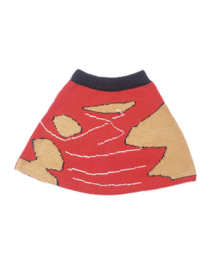Red wool skirt laid flat on white background. The skirt is predominantly red with spots of beige and five white lines.